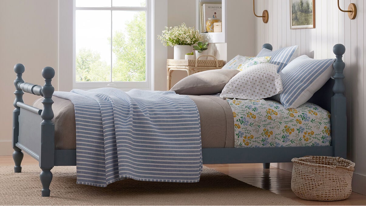 Image of bed with different pattern bedding in blue, white and yellow