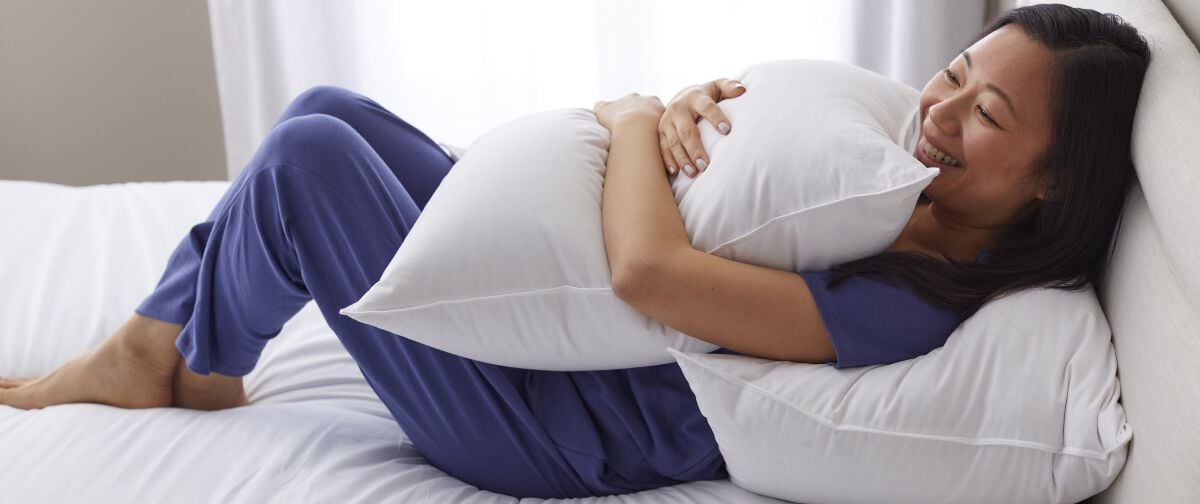 woman holding white pillow