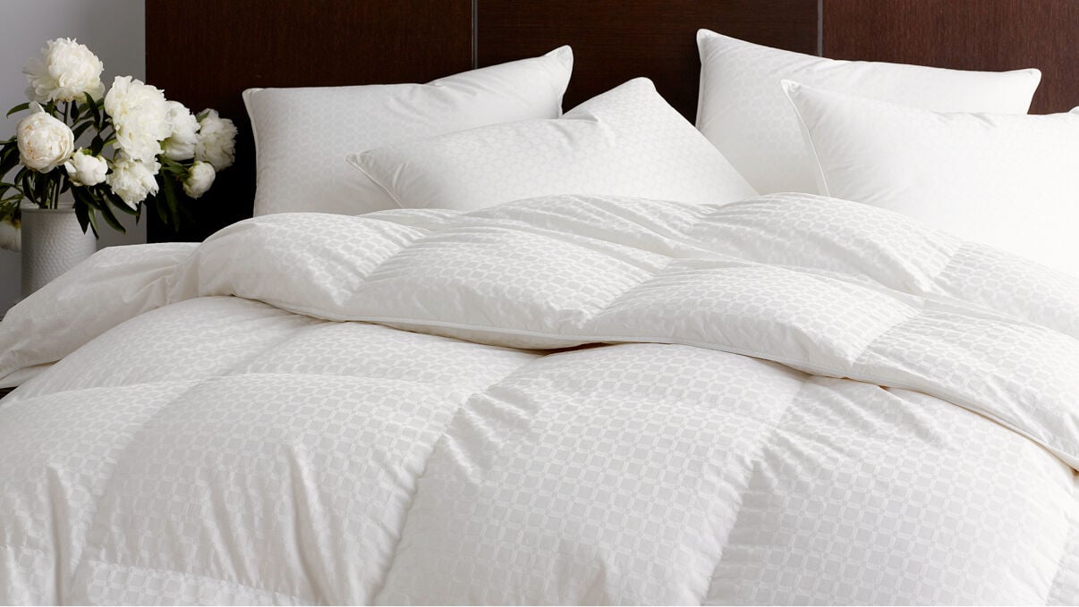 Image of a lofty white comforter and pillows