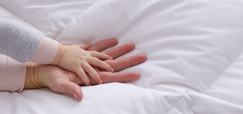 Image of two hands on a duvet insert