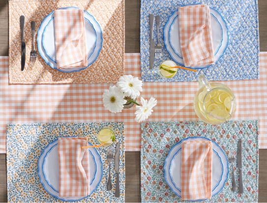 Table set with bright floral and gingham linens