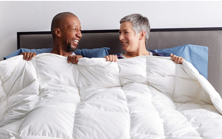 Man and woman under a dual comforter