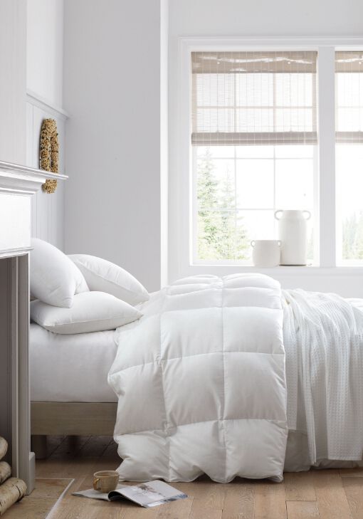 Image of fluffy white comforter on bed