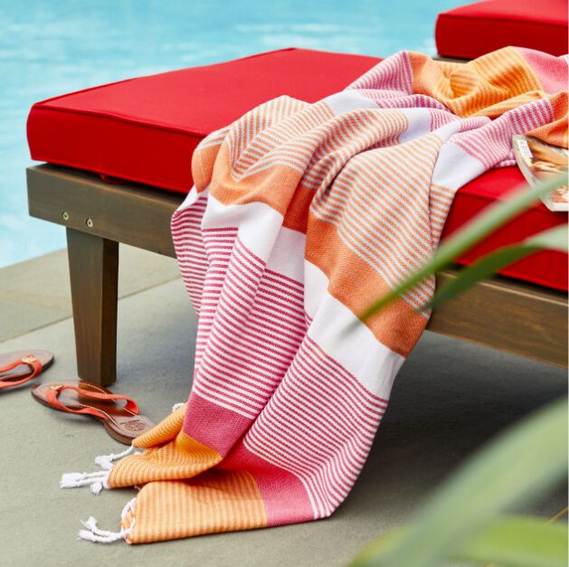 Bright striped hammam towel on red lounge chair