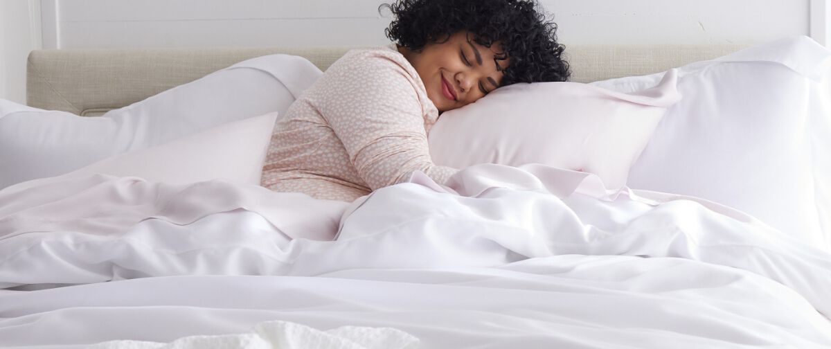 Woman snuggling in lyocell bedding