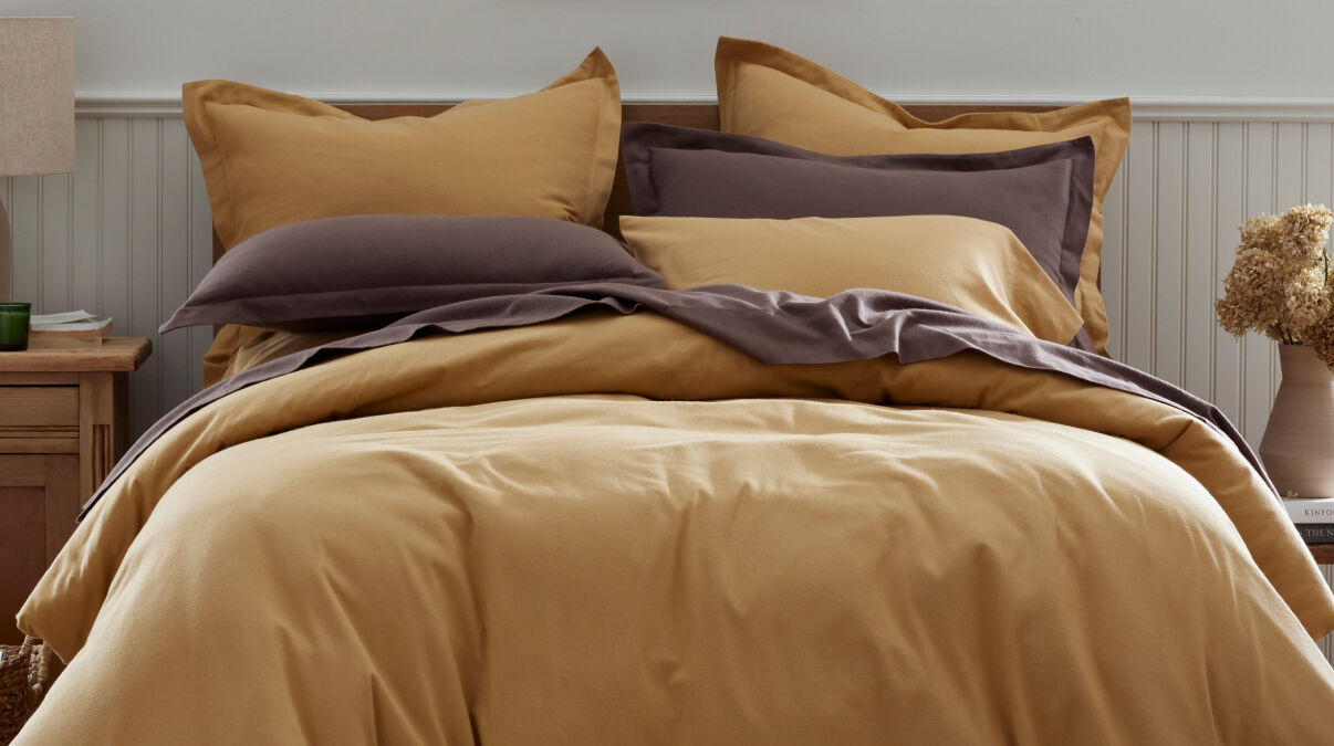 Image of bed made with gold duvet cover Image of bed made with gold duvet cover