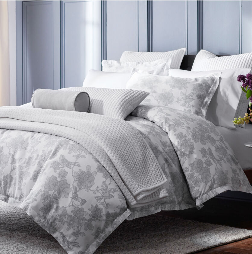 floral bedding with several throw pillows